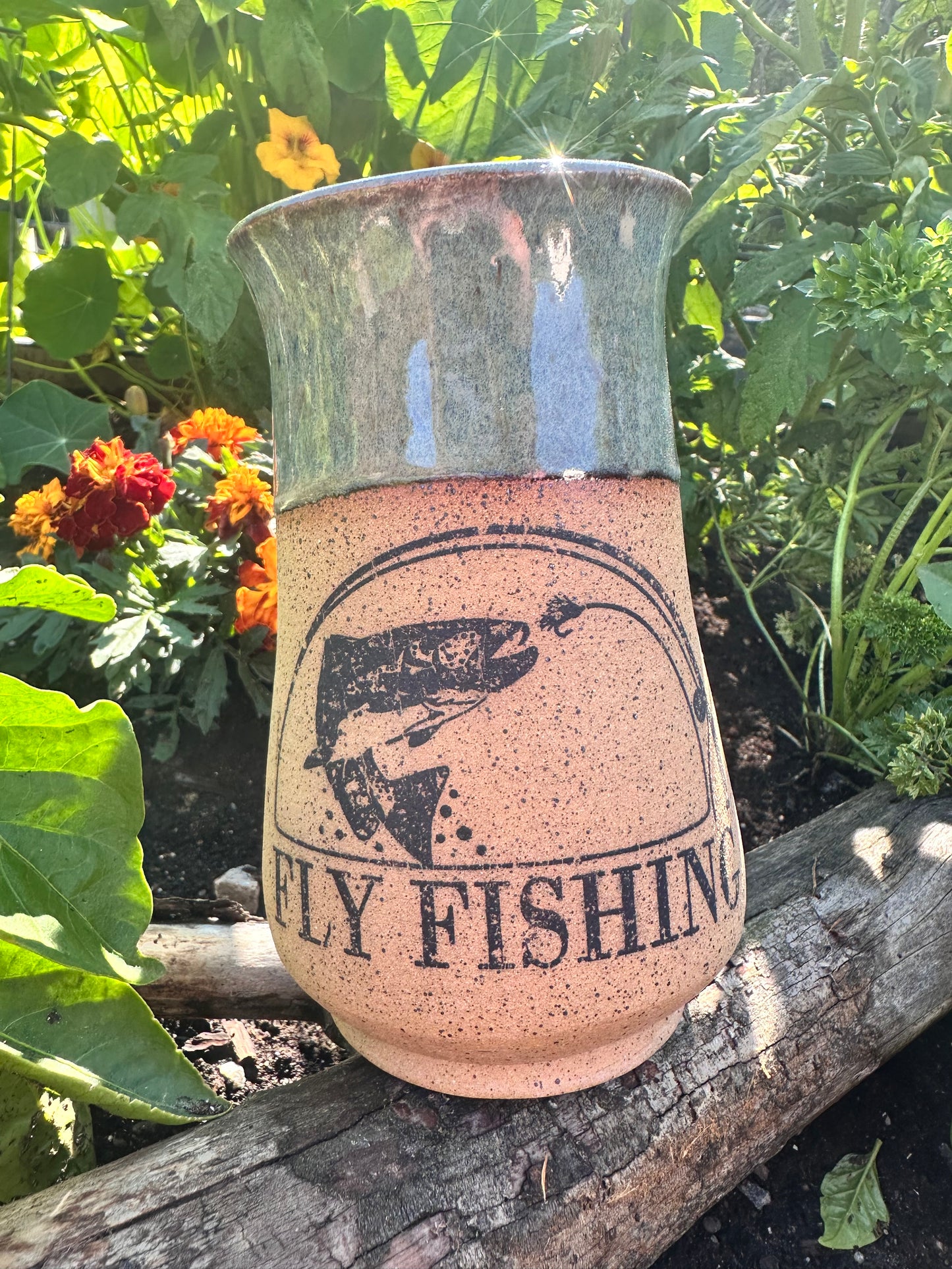 Handmade ceramic mug with fly fishing design