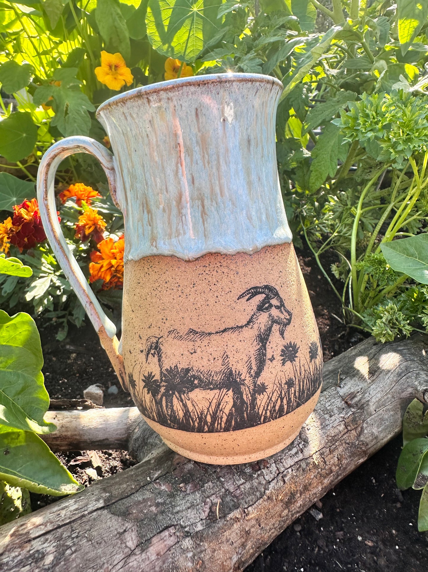 Handmade ceramic mug with wildflower and goat design