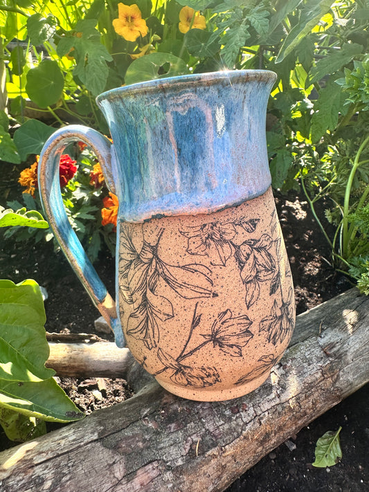 Handmade ceramic mug with magnolia flowers design