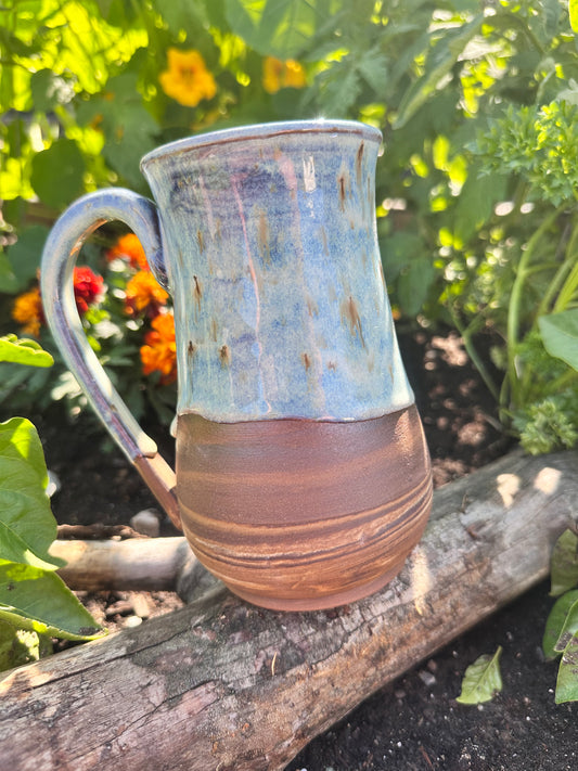 Handmade ceramic mug with spiral clay design. 